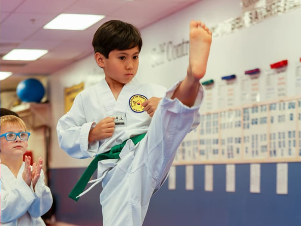 an asian boy in taekwondo uniform doing taekwondo kick in Norristown PA